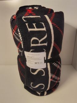 Victoria's Secret Cozy Plush blanket with a classic black and red plaid pattern with bold branding
