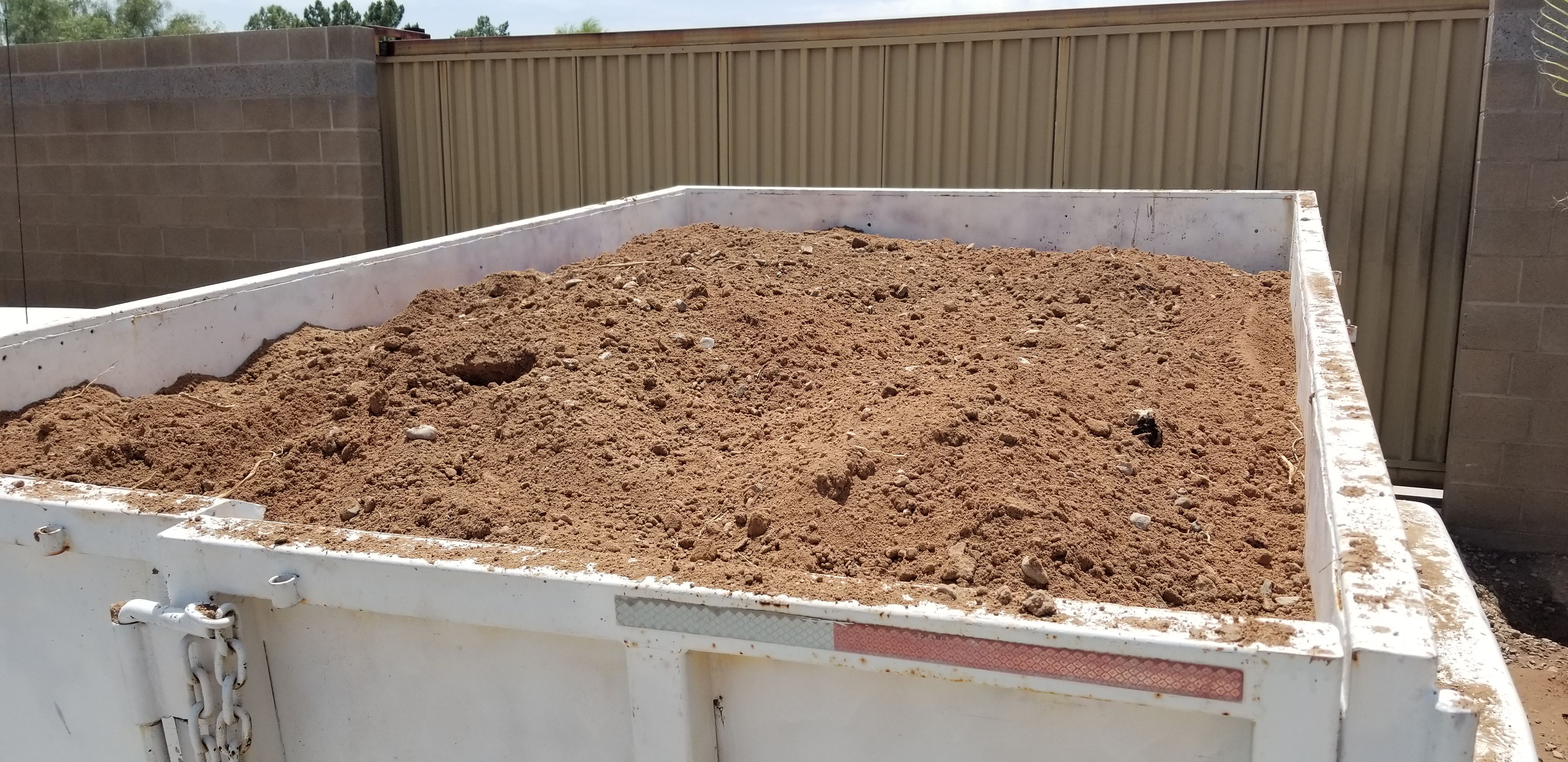 Clean fill dirt delivered. The dump trailer is 6 ft by 10 ft by 2 ft