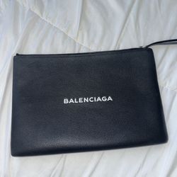 Balenciaga Pochette in black. 