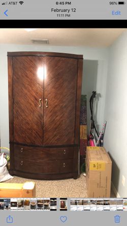 Beautiful solid armoire can hold tv, has bar for clothes and has four drawers for storage
