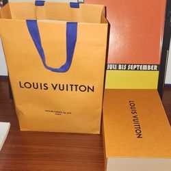 Louis Vuitton shopping bag and a Louis Vuitton box. 