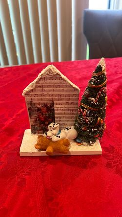 Christmas dalmatian dog playing with bear next to Christmas tree in the house snow with glitters  decoration