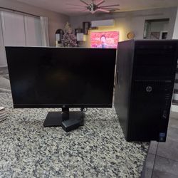 HP Z210 workstation with an accompanying HP monitor and power adapter. 