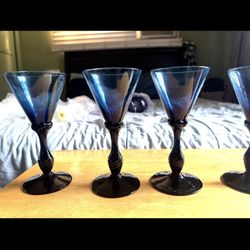 blue wine glasses in the image appear to be antique, possibly Georgian-e