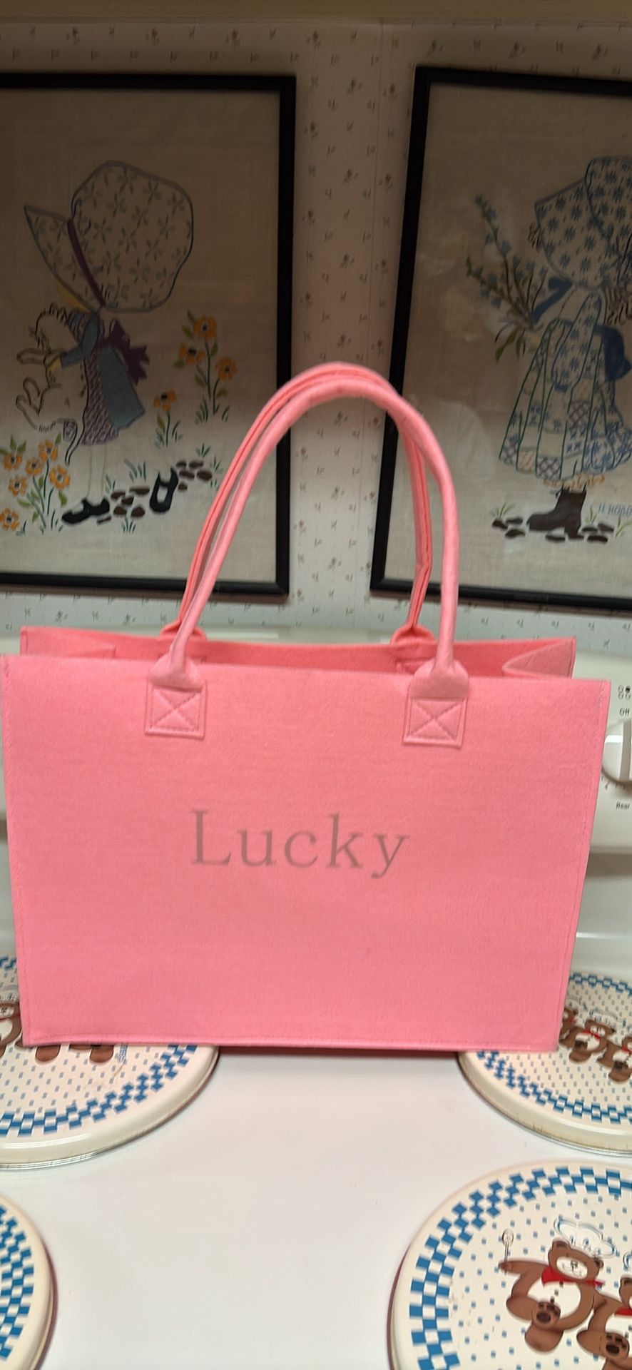Bubble gum Pink felt tote lucky written across front 2 handles Measures 15.5”