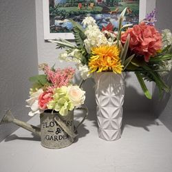 Vase with flowers and small water can with flowers