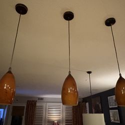 3 amber pendant lights