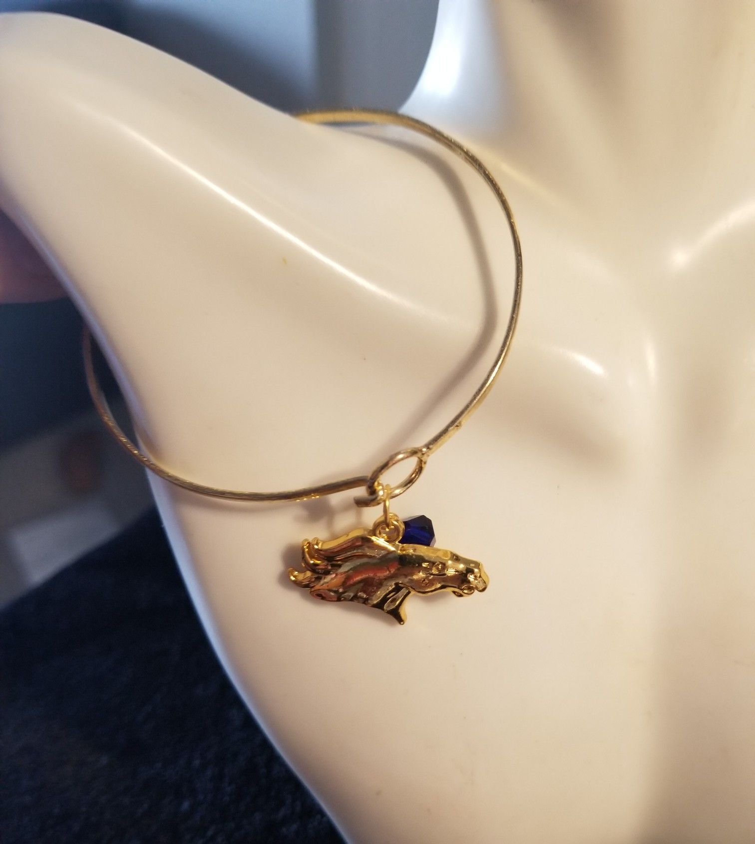 Gold denver bronco charm with blue Swarovski bead