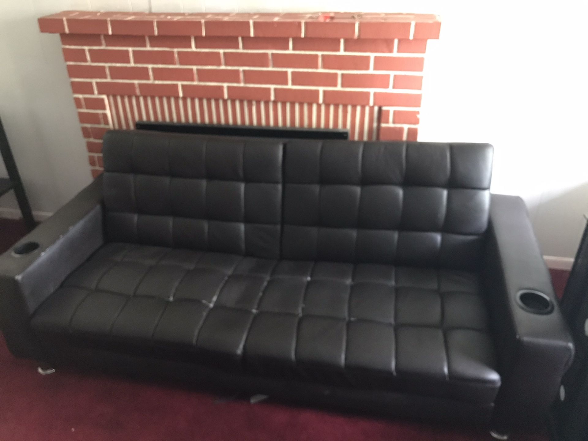 Black futon couch with cupholders