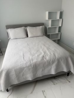 Gray Upholstered Bed and mattress .