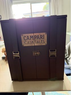Rare Campari Cask Tales collector’s presentation case with three bottles, beautifully displayed in a leather-style trunk. A unique and elegant piece f