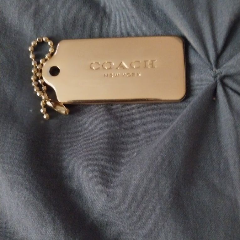 Coach gold metal hang tag deals