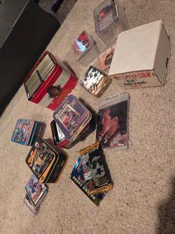 Assorted Nascar collector tins and cards.