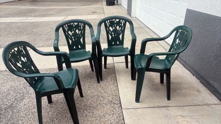 Four green patio chairs