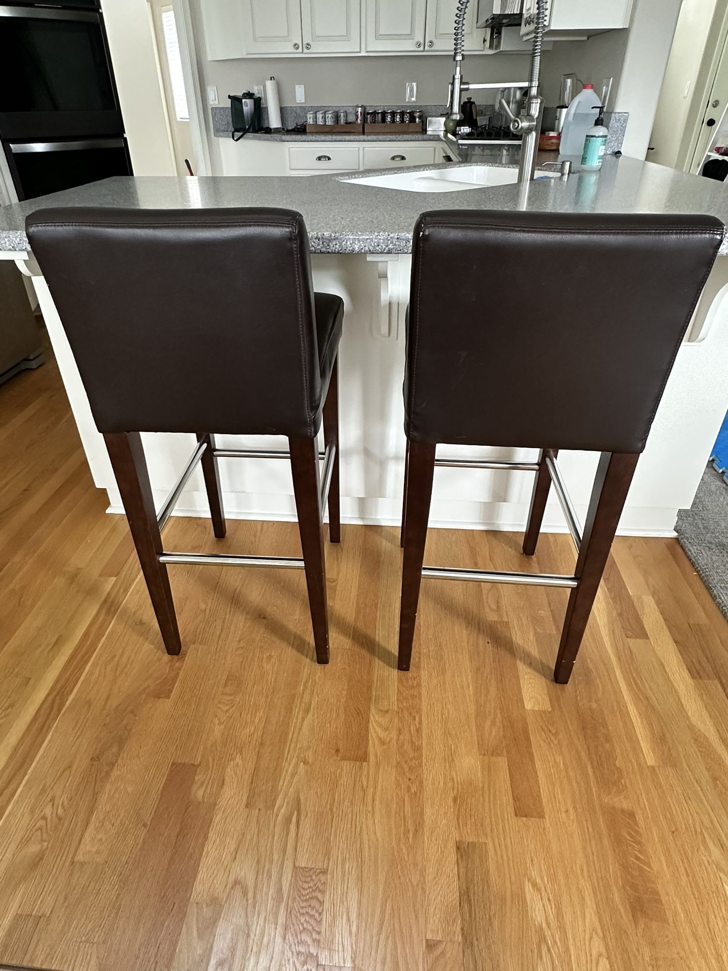 2 Brown leather bar stool, wood legs, $80 for two chairs