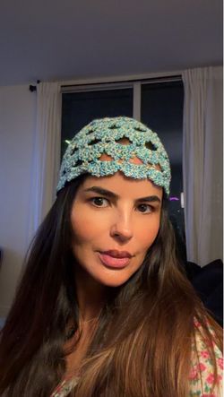 Handmade crochet hat in blue and yarn in a textured, openwork pattern