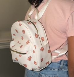 Mini backpack with adjustable straps, and 2 zipper pockets with little bears