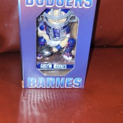 Austin Barnes Los Angeles Dodgers bobblehead.
It features the player in a catching stance, wearing the team's blue and white uniform.
The bobblehead i