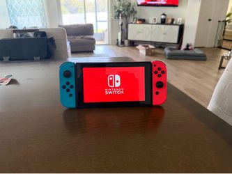 Nintendo Switch with Blue and Red Joy-Cons and Case