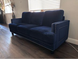 Royal blue velvet sofa with nailhead trim