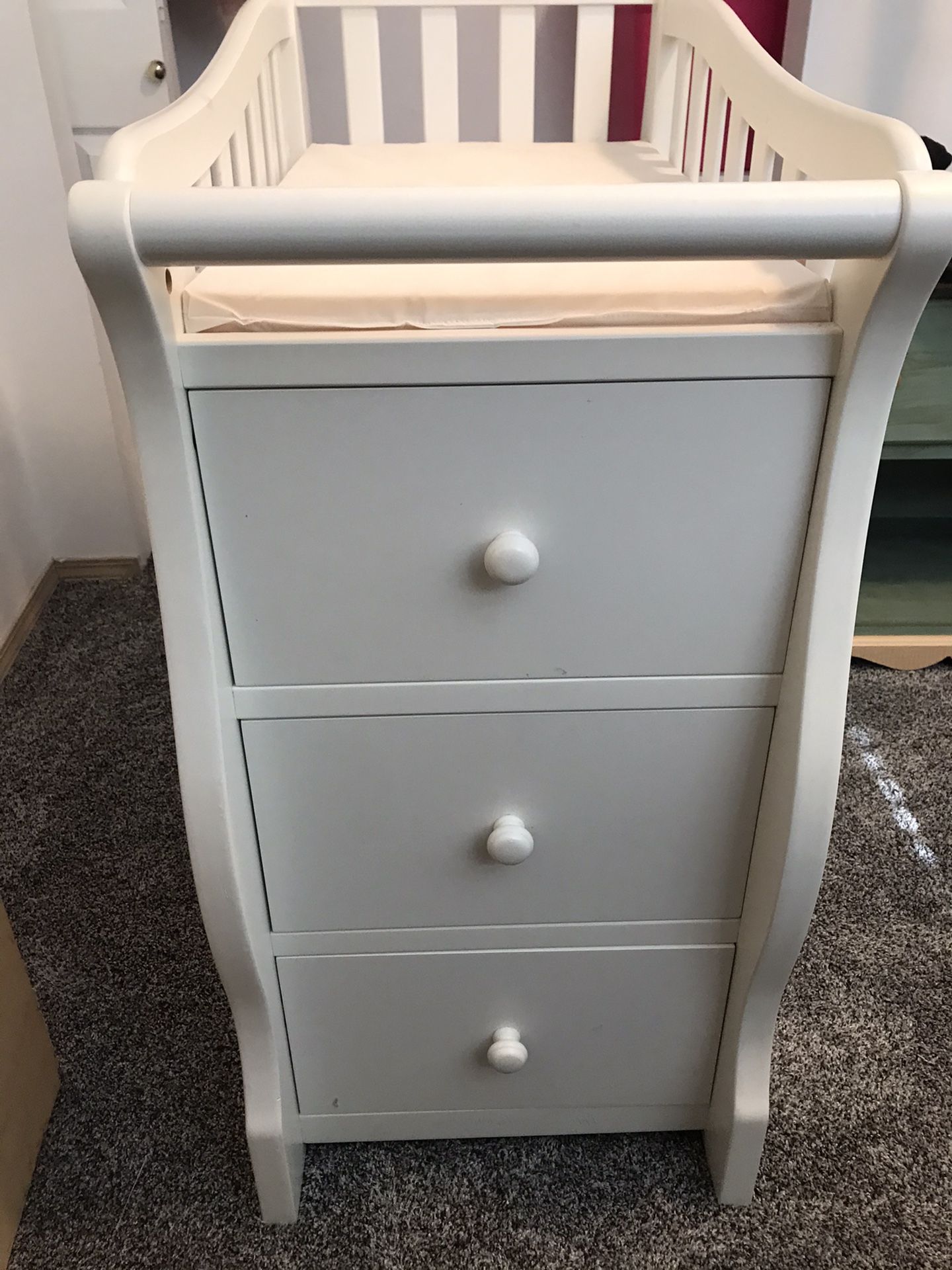 White changing table with drawers and shelves