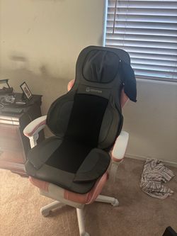 Pink gaming chair with cofier massage attachment