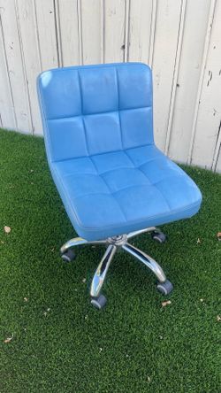 an armless grid-tufted swivel task chair in light blue faux leather