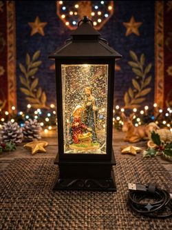 Christmas Nativity scene lantern with swirling glitter and warm light