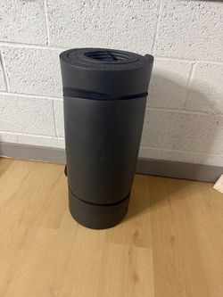 Black Foam Exercise Mat Rolled Up