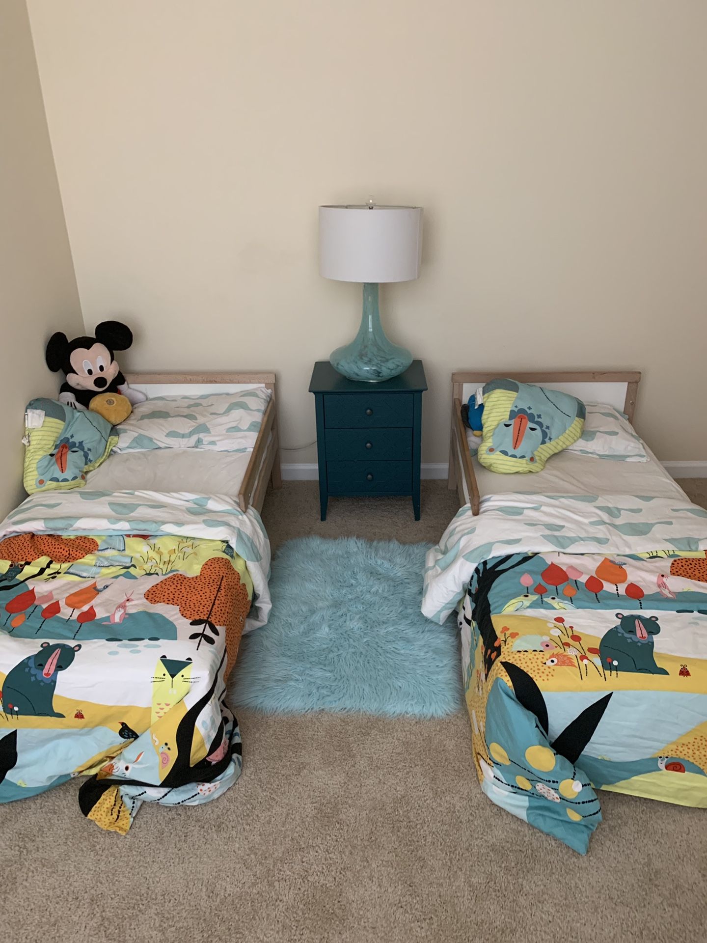 Two toddler beds with protector ,fitted sheets ,blankets , matching curtains