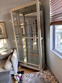 Silver curio with mirrored back and light