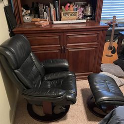  Stressless reclining swivel leather armchair and matching ottoman. Black leather