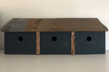 3 Hole Royal Blue Birdhouse with Tin Roof. 24 inches wide by 9 inches tall by 7 inches deep.