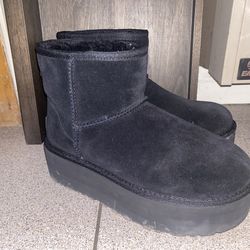 This is a pair of UGG Classic Mini Platform boots in black suede.