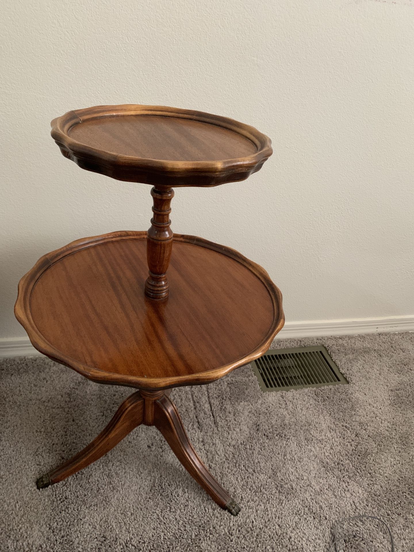 Antique two-tiered "pie crust" table, also known as a dumbwaiter table.