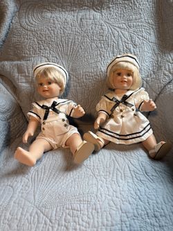 $5 Pair Of Sailor Porcelain Dolls, Sitting 8”Tall Absolutely Adorable With Blonde Hair Blue And White Outfits Missing One Shoe
