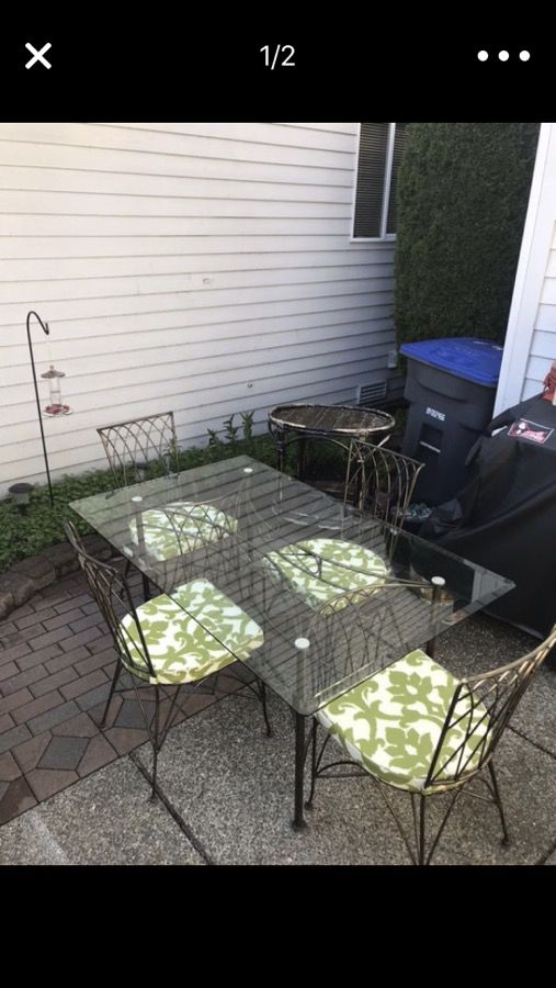 Wrought Iron table and chairs and cushions- pending pick up