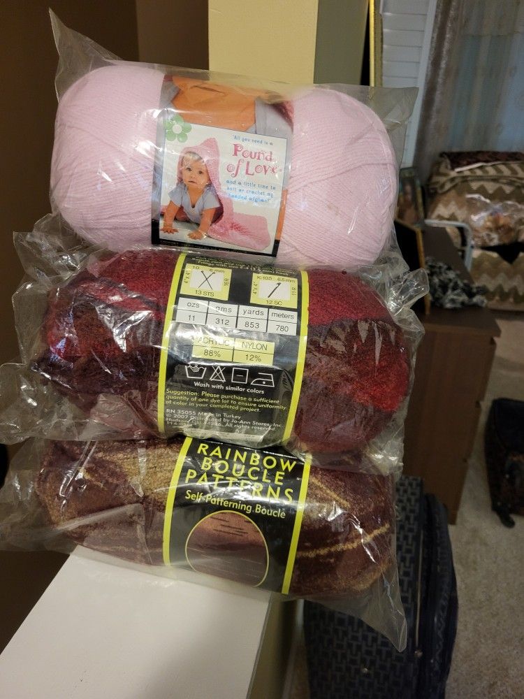 Yarns. 2 Rolls Red Boucle+2 Rolls Burgundy +1 Roll Pinc Regular Yarn.