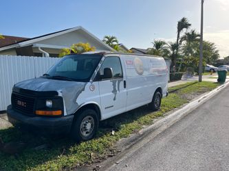 White GMC Savana cargo van