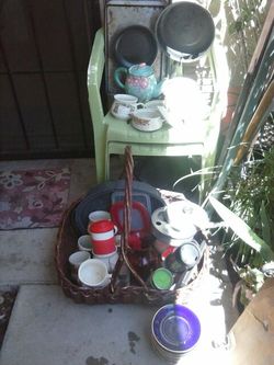 Lots of dishes, pans, baking sheets,bowls , cups, food storage containers, and vase