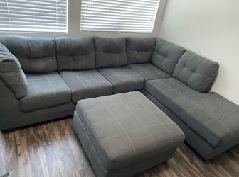 Grey sectional couch with ottoman