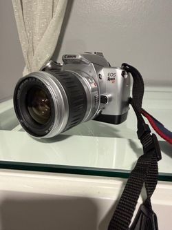 Canon EOS Rebel Ti 35mm autofocus SLR film camera equipped with a Canon EF zoom lens