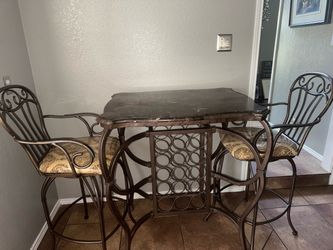 Wrought Iron High Bar Table w/2 chairs and wine rack in the middle