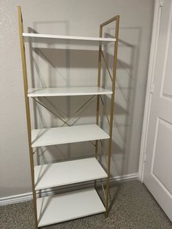White and gold bookshelf