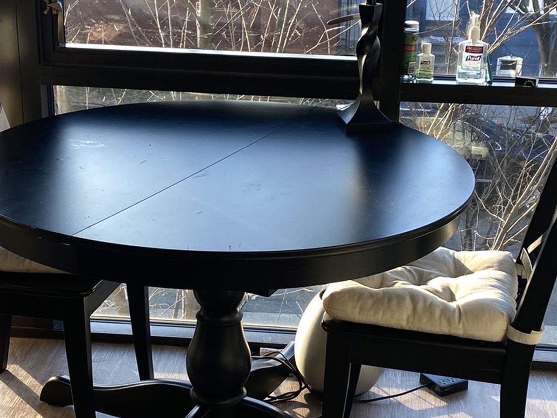 Black Dining Room Table With Four Chairs Originally From IKEA. Comes With Eggshell Colored Seat Cushions. Table Can Expand From Internal Leaf.