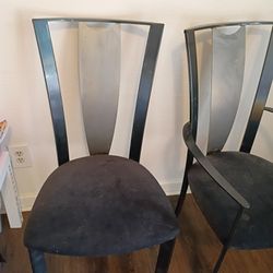 This product is a set of 4 modern dining chairs with a sleek brushed metal backrest