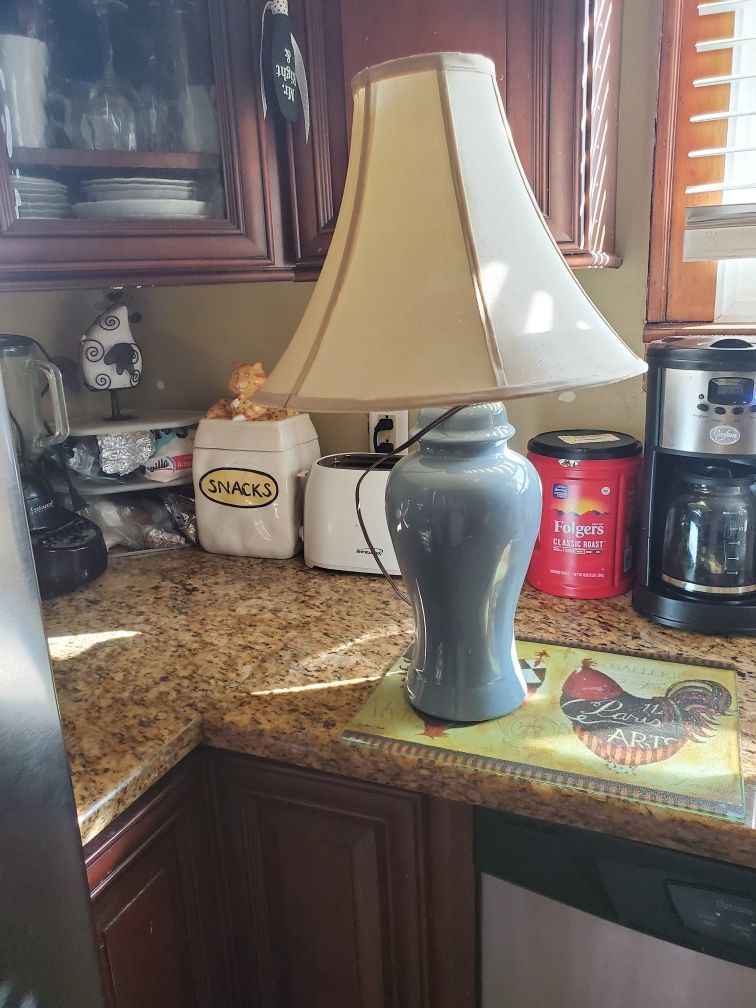 Blue table lamp with shade. Shade slightly bent but can be corrected.