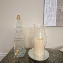 White bottle and big candle with the holder and Mirror 