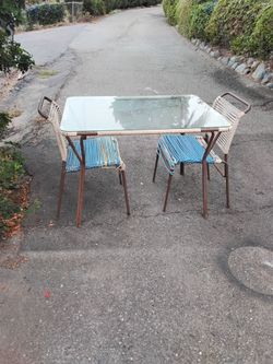 Clearance Sale patio table with chairs.  30x42". Scratches and rust