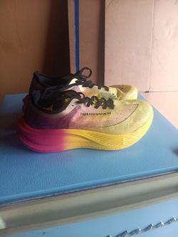 Irunsvan Heat 1.0 carbon plate marathon running shoes featuring a vibrant yellow, pink, and purple gradient colorway.